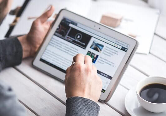 Browsing internet with cup of coffee